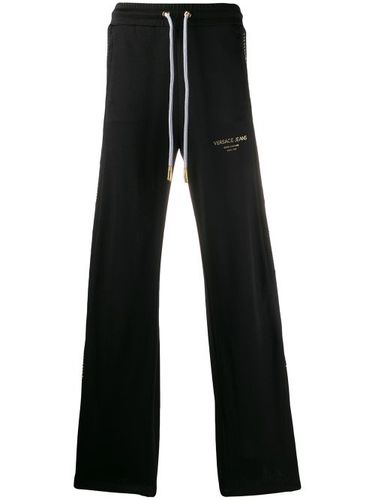 Pantalon de jogging ample à empiècement brodé - Versace Jeans Couture - Modalova
