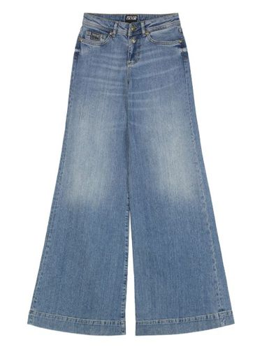 Jean ample à design cinq poches - Versace Jeans Couture - Modalova