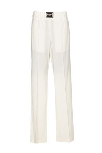 Flare Trousers With Logo Plaque - Dolce & Gabbana - Modalova