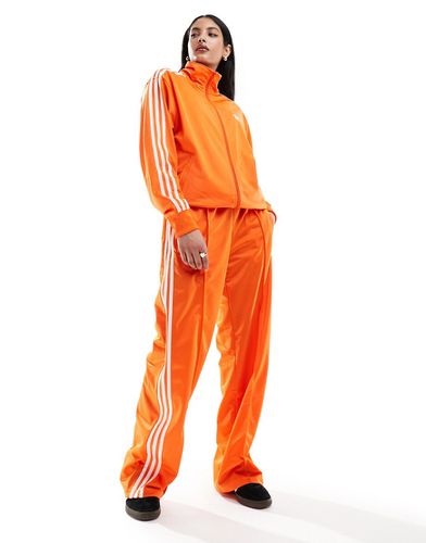 Firebird - Pantaloni della tuta ampi arancioni - adidas Originals - Modalova