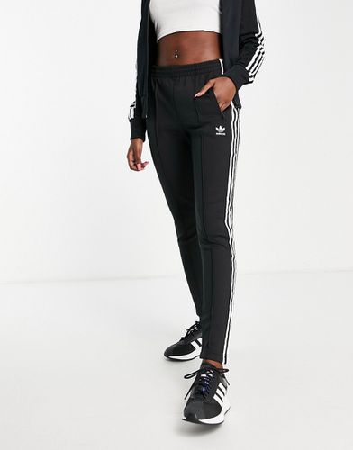 Joggers neri con tre strisce e fondo aderente - adidas Originals - Modalova