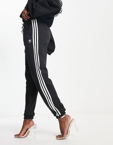 Joggers neri con tre strisce e fondo aderente - adidas Originals - Modalova