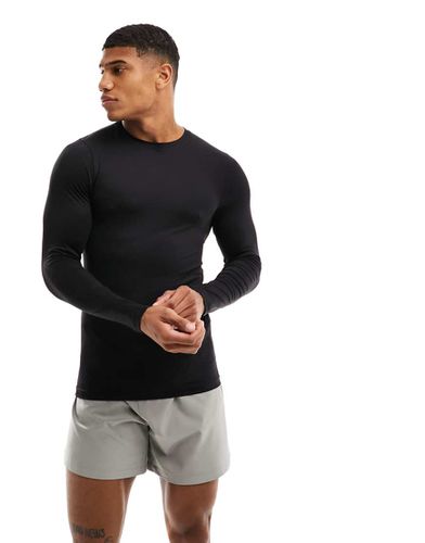 Base layer sportivo aderente a maniche lunghe in tessuto tecnico termico - ASOS - Modalova