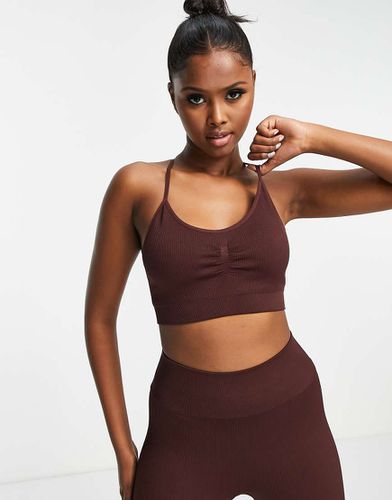 Reggiseno sportivo a supporto leggero senza cuciture a coste - ASOS - Modalova