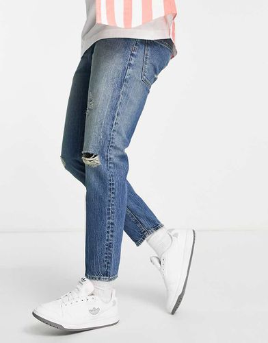 Jeans classici rigidi lavaggio tinto con strappi sulle ginocchia - ASOS DESIGN - Modalova