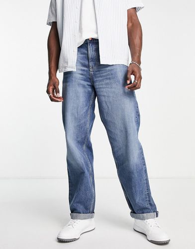Jeans extra larghi con cimosa lavaggio medio - ASOS DESIGN - Modalova