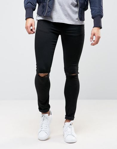 Jeans extreme skinny neri con strappi alle ginocchia - ASOS DESIGN - Modalova