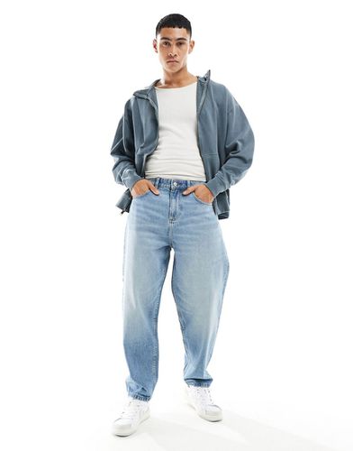 Jeans oversize affusolati lavaggio medio - ASOS DESIGN - Modalova