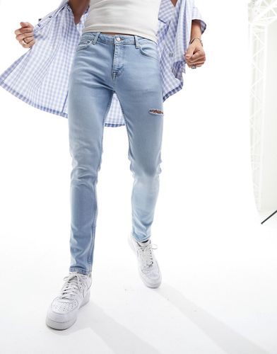 Jeans skinny lavaggio chiaro con strappi sulla coscia - ASOS DESIGN - Modalova