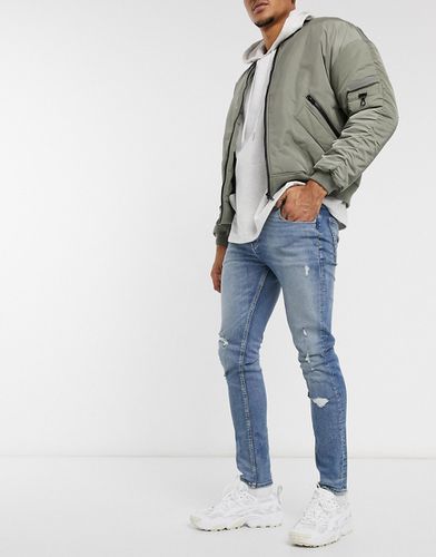 Jeans skinny con strappi chiaro slavato - ASOS DESIGN - Modalova