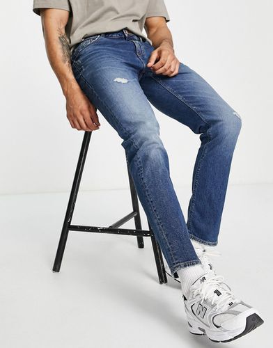 Jeans slim elasticizzati lavaggio scuro con abrasioni - ASOS DESIGN - Modalova