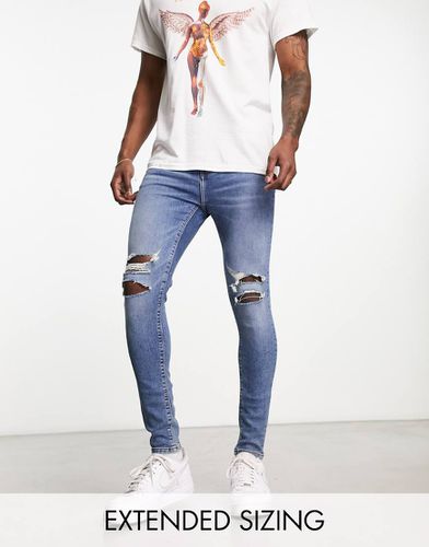 Jeans spray power stretch lavaggio medio - ASOS DESIGN - Modalova