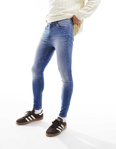 Jeans spray power stretch lavaggio medio - ASOS DESIGN - Modalova