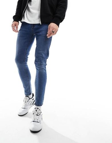 Jeans spray power stretch lavaggio medio - ASOS DESIGN - Modalova