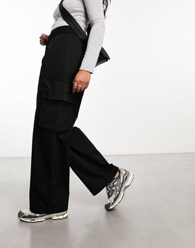 Pantaloni neri con tasche - ASOS DESIGN - Modalova