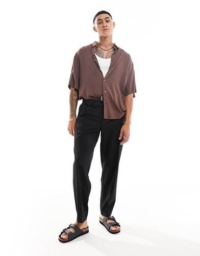 Pantaloni oversize eleganti affusolati neri con bottoni - ASOS DESIGN - Modalova