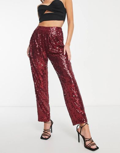 Pantaloni affusolati rossi con paillettes - ASOS DESIGN - Modalova