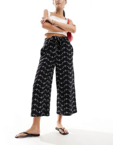 Pantaloni culotte a fondo ampio in pizzo con cintura annodata - ASOS DESIGN - Modalova