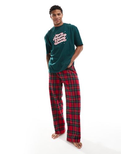 Pigiama composto da T-shirt con scritta "Christmas Whatever" e pantaloni rossi a quadri - ASOS DESIGN - Modalova