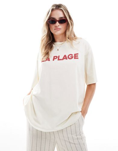 T-shirt boyfriend color crema con grafica "La Plage" - ASOS DESIGN - Modalova