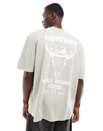 T-shirt oversize grigia con stampa "Cowboy" sul retro - ASOS DESIGN - Modalova