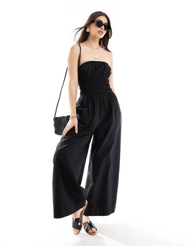 Tuta jumpsuit a fondo ampio nera con corpino arricciato - ASOS DESIGN - Modalova