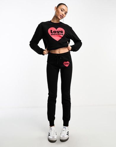 Joggers neri con logo a cuore in coordinato - Love Moschino - Modalova