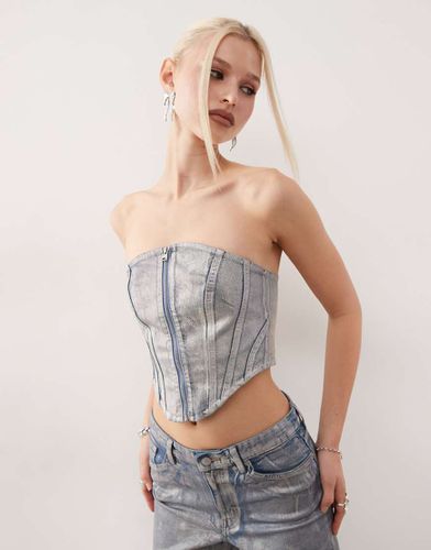 Top a corsetto in denim con lavaggio olografico in coordinato - Monki - Modalova