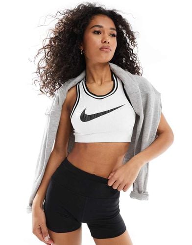 Reggiseno sportivo in jersey a supporto leggero con logo - Nike Training - Modalova