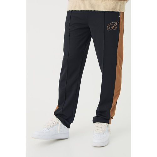 Pantaloni tuta in piqué con ricamo di B e pannelli - boohoo - Modalova