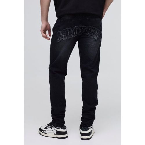 Jeans Skinny Fit in denim Stretch in lavaggio acido con applique - boohoo - Modalova