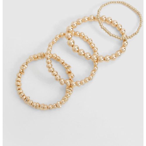 Bracciali impilabili color oro con perline - set di 4 paia - boohoo - Modalova