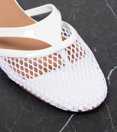 Alaïa Mules Infradito in rete e pelle - Alaia - Modalova