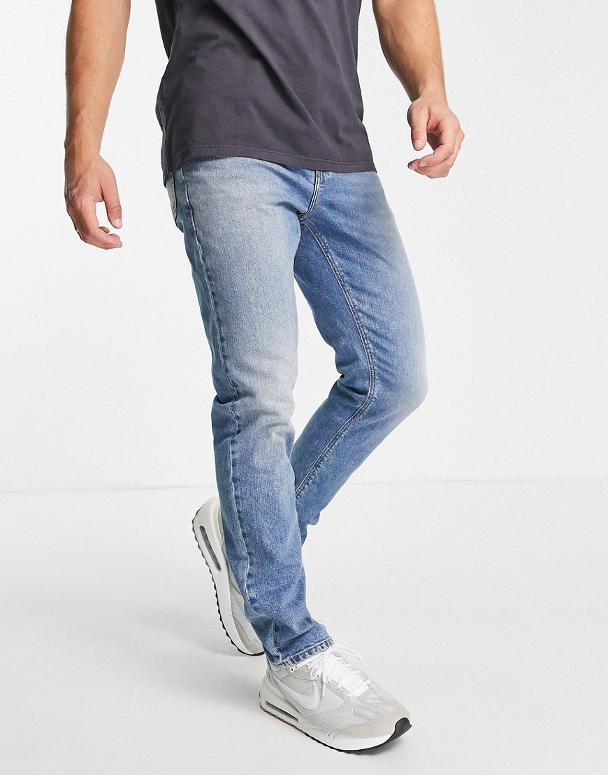 Jeans slim elasticizzati vintage lavaggio medio - ASOS DESIGN - Modalova